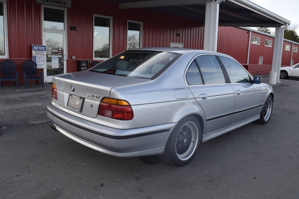 The rear 3/4 view of a silver modified 1997 BMW 540i M-Sport