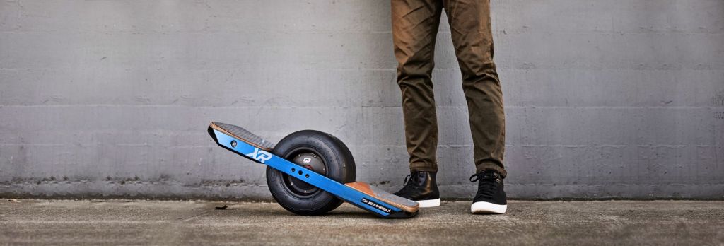 The Onewheel Plus XR unicycle scooter at the foot of a rider.
