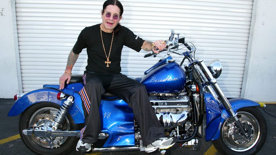 Ozzy Osbourne sits on a motorcycle