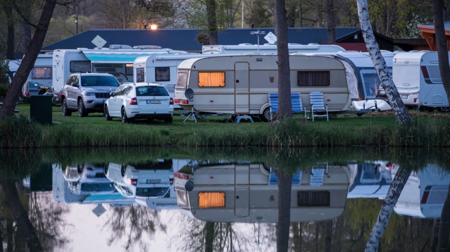 Campers set up in RVs by a lake