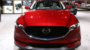 A red Mazda CX-5 on display at an auto show