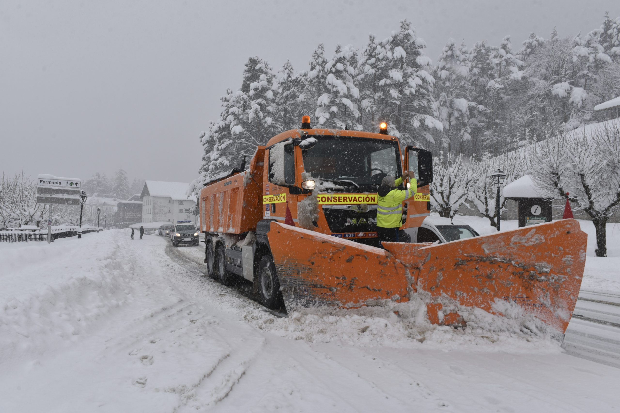 A snowplow clearing a snow-filled road