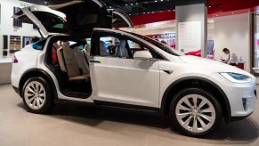 A white Tesla Model X electric SUV seen in a showroom
