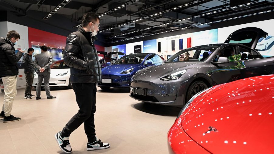 People look at a Tesla Model Y car at a Tesla showroom in Beijing on January 5, 2021