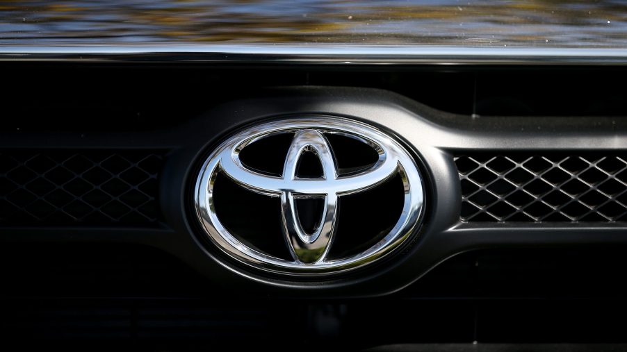 The Toyota logo displayed on the front grille of a truck
