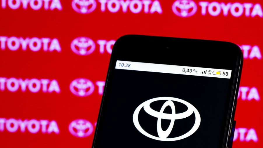 In this photo illustration, a Toyota logo seen displayed on smartphone