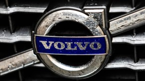 Raindrops on a Volvo logo on a car grille