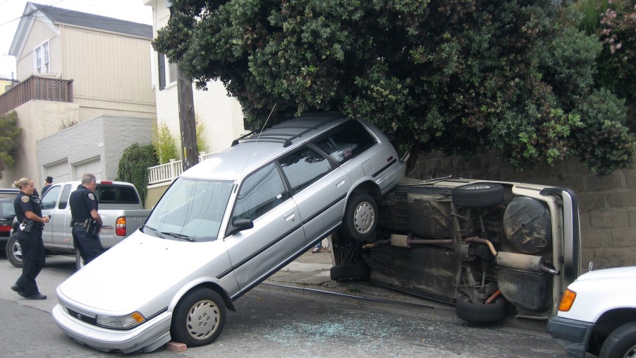 A silver station wagon reversing out of a driveway in August 2006 struck a 2002 BMW and overturned it