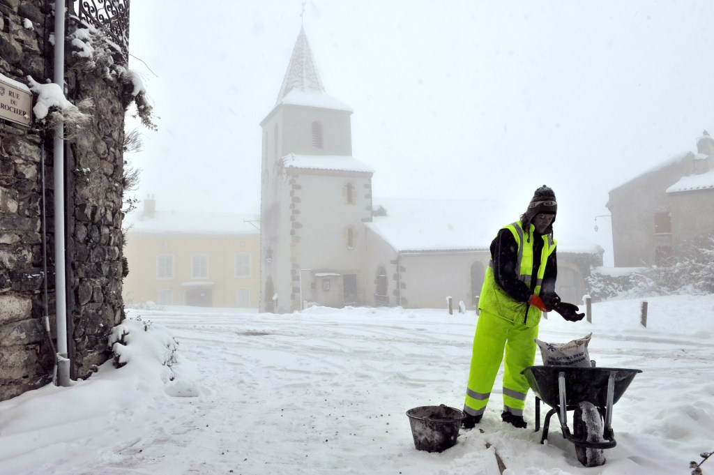 man salting the road