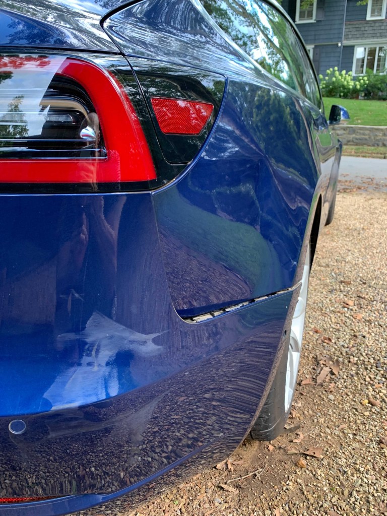 The rear panel damage to the Tesla Model 3 