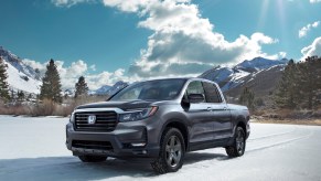 The 2021 Honda Ridgeline RTL-E parked in an open plain in front of trees.