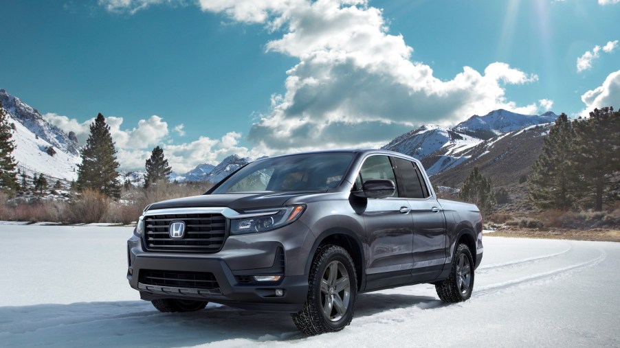 The 2021 Honda Ridgeline RTL-E parked in an open plain in front of trees.