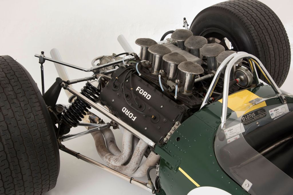 The rear-mounted V8 engine acting as a stressed member for the green-and-yellow 1967 Lotus 49 R3 DFV