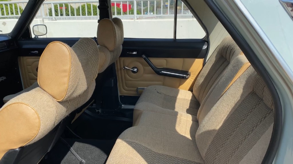 The tan-cloth rear seats and light-brown door panels of the 1988 Volga GAZ-24-10