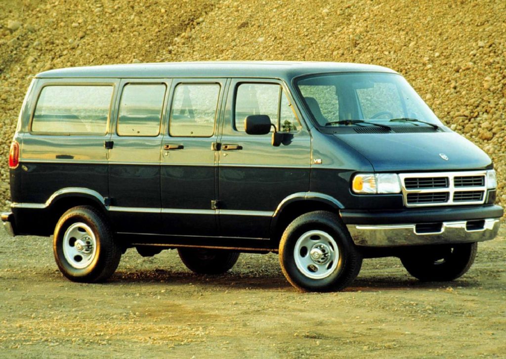 A black 1996 Dodge Ram van in a quarry