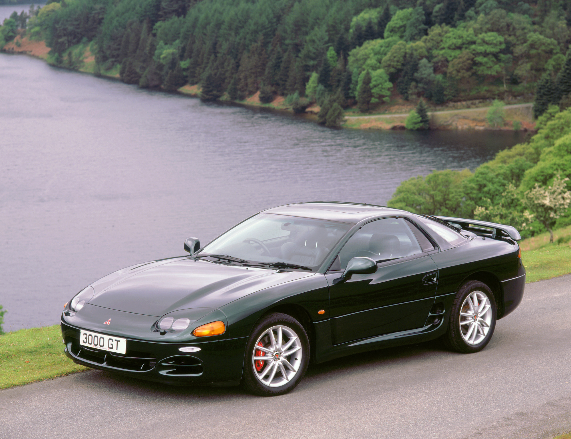A black 1999 Mitsubishi 3000GT parked by a Welsh reservoir in 2000