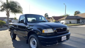 A black 2000 Mazda B3000 SX on a neighborhood street