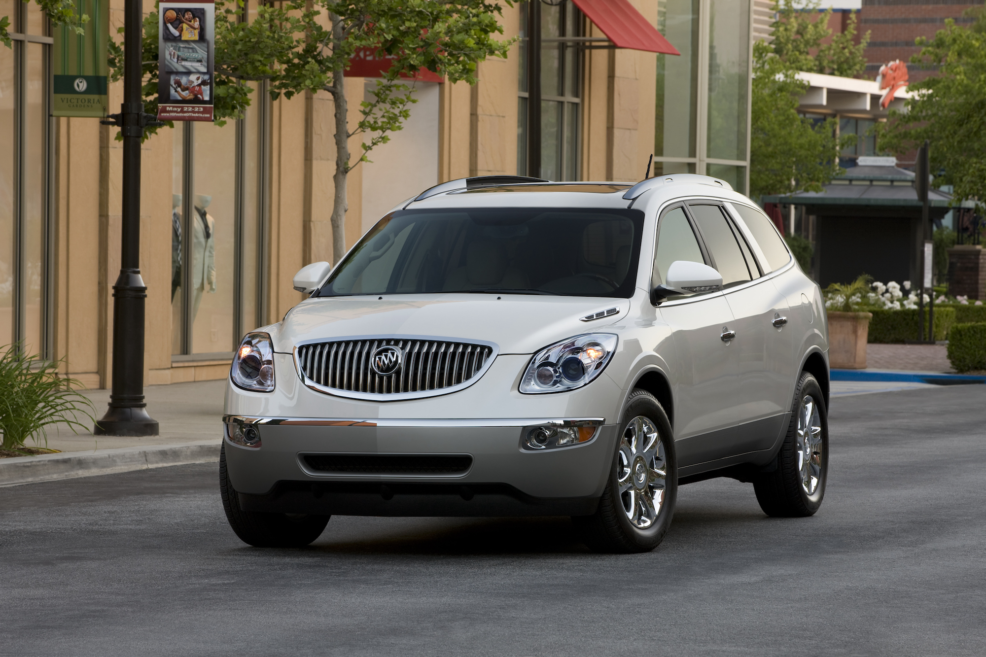 A white 2012 Buick Enclave luxury crossover SUV stopped on a city street