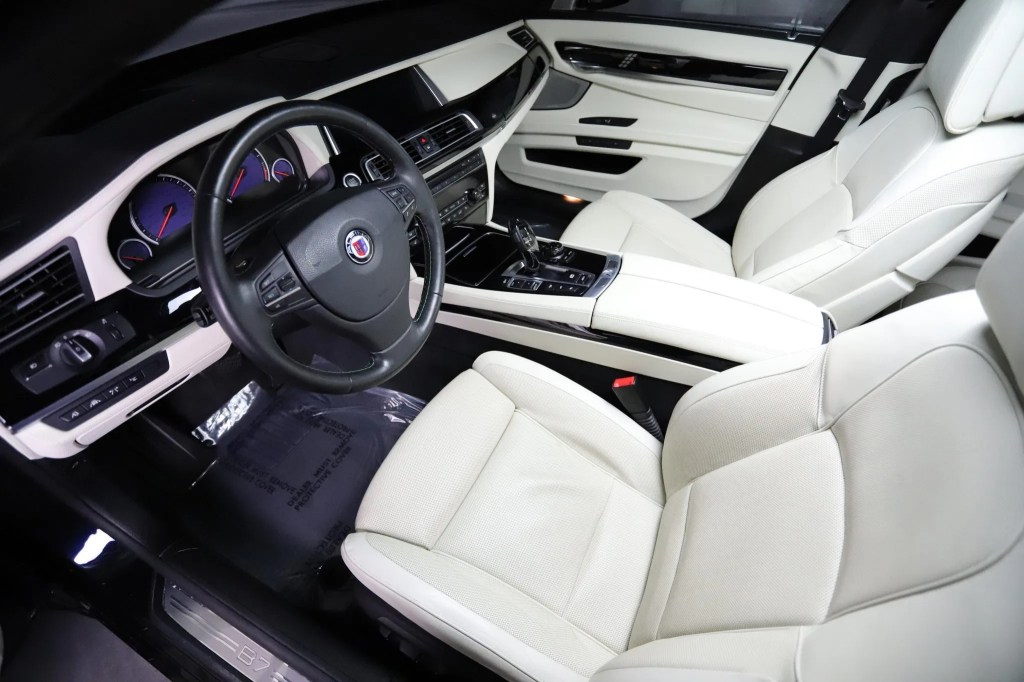 The white-leather front seats and black interior trim of a 2013 BMW Alpina B7 xDrive