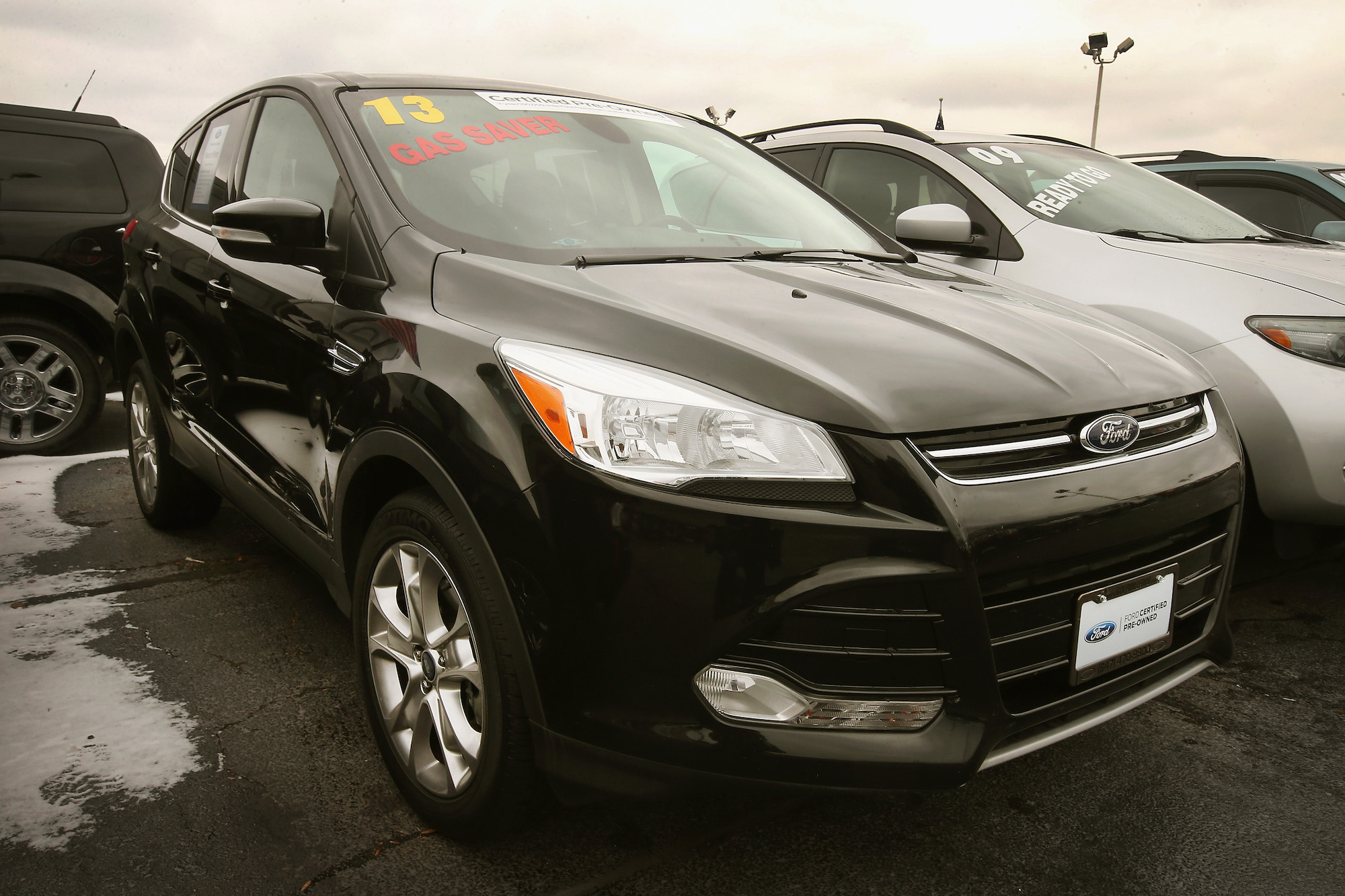 A black 2013 Ford Escape compact SUV sits at a dealership on November 26, 2013, in Niles, Illinois