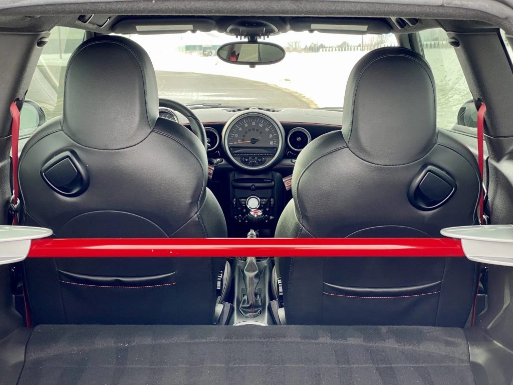 The red cross-bar and black-leather seats of the 2013 Mini Cooper John Cooper Works GP as seen from the rear
