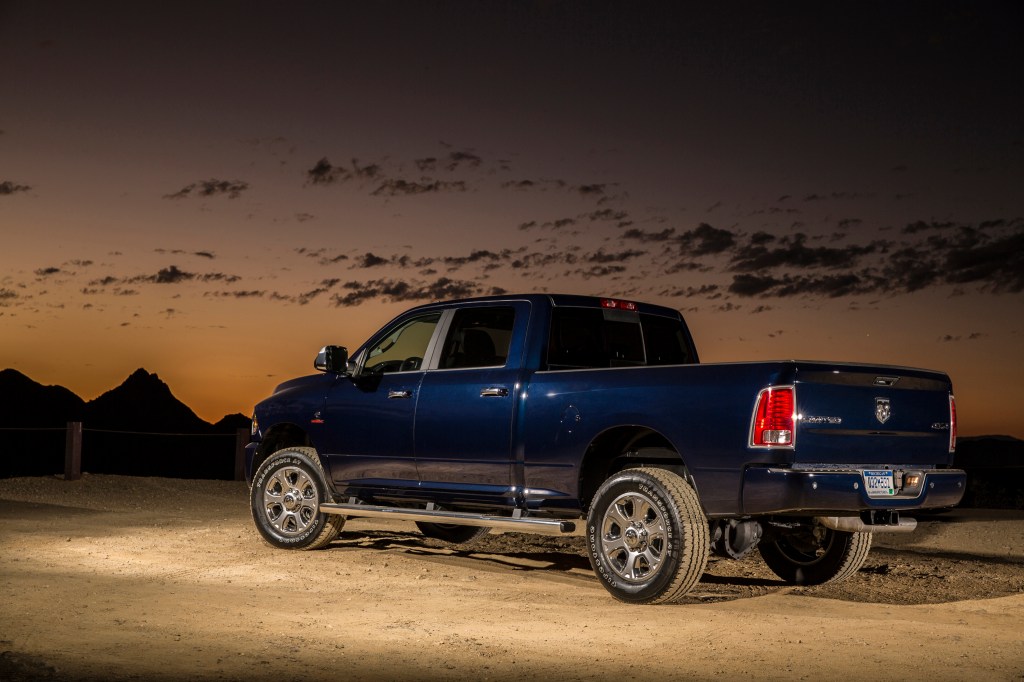 A blue 2014 Ram 2500 Heavy-Duty truck parked facing away from the camera during dusk