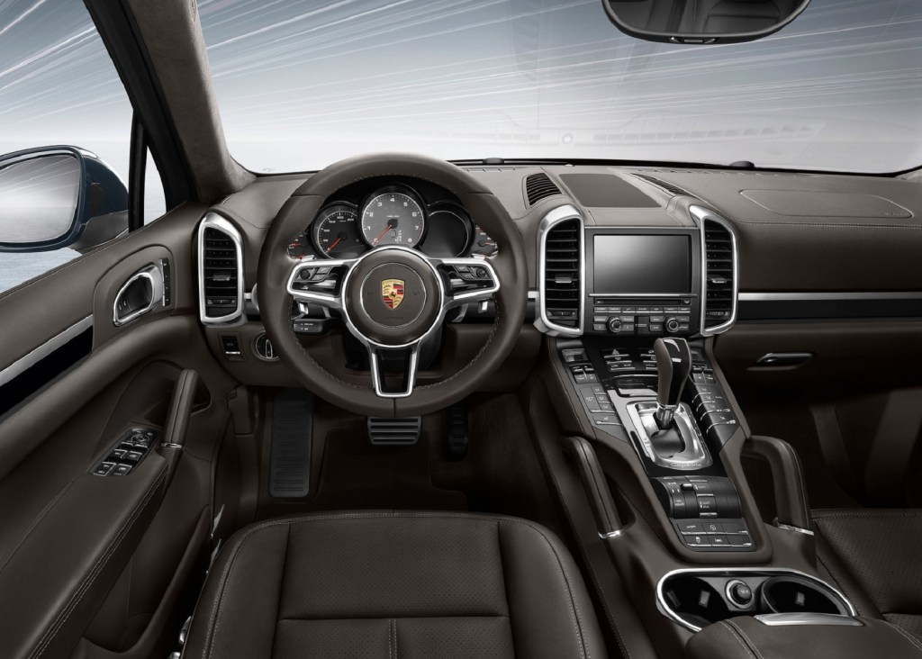 The brown-leather front seats and dashboard of a 2016 Porsche Cayenne