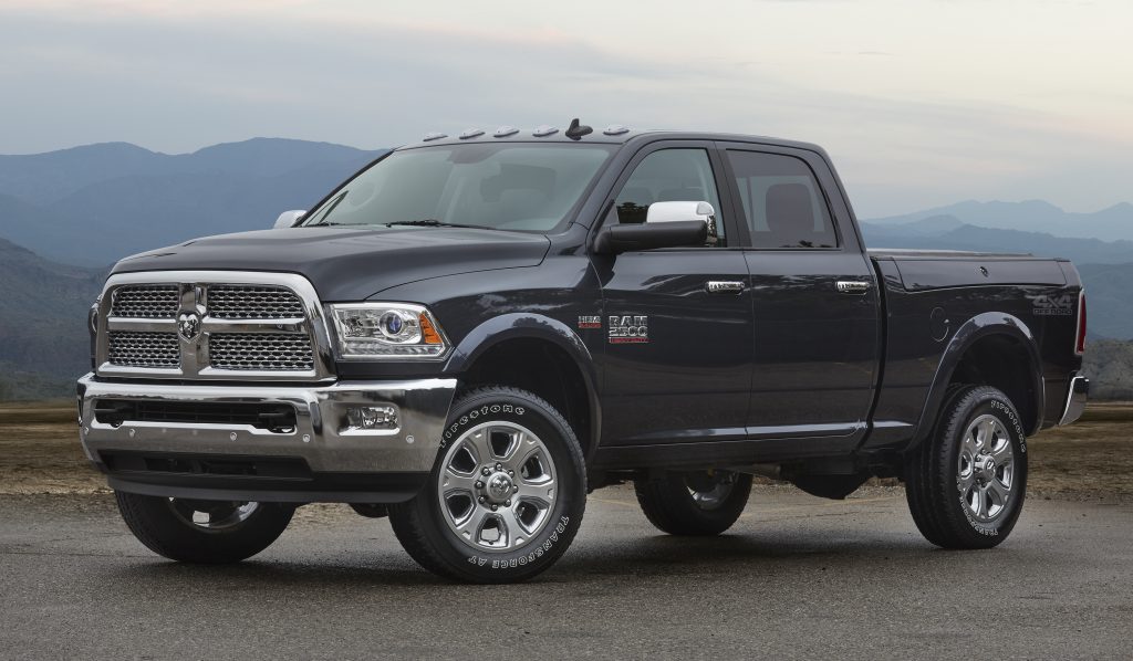 A black 2018 Ram 2500 parked on pavement with a mountain range in the background