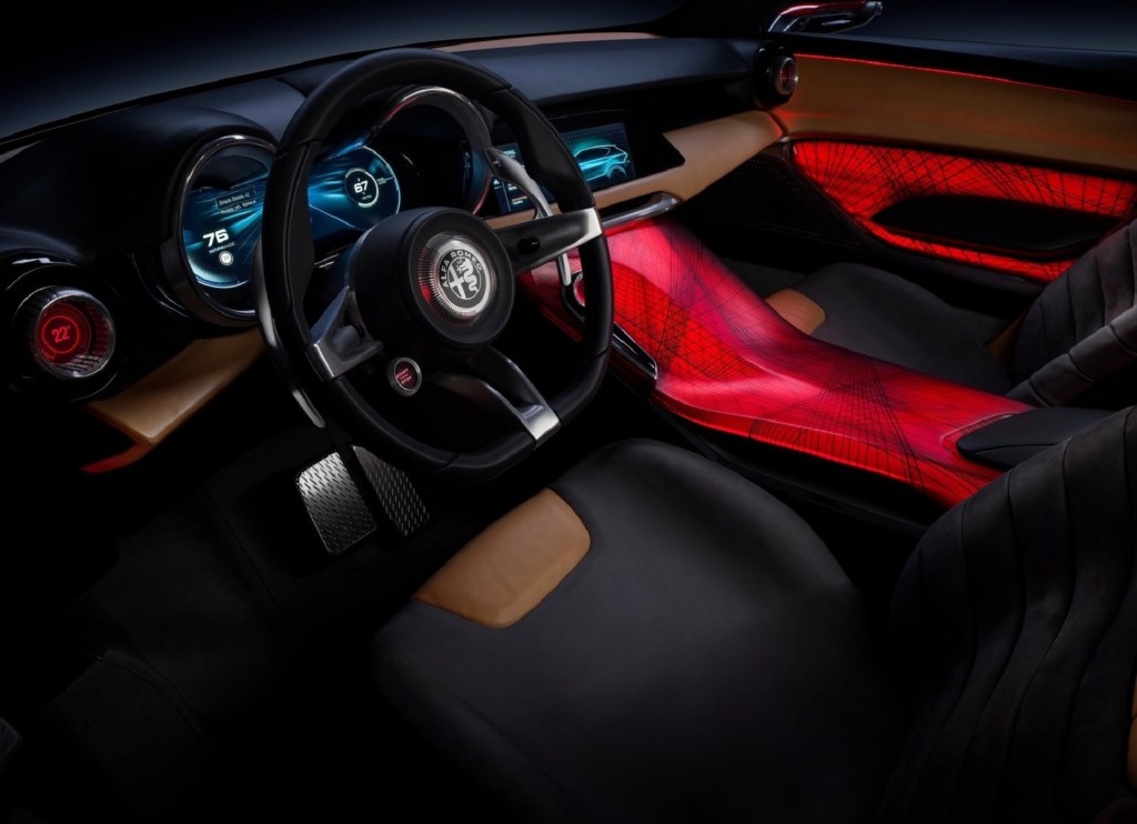 The red-lit center console and the tan-and-black-leather-upholstered front seats and dashboard of the 2019 Alfa Romeo Tonale Concept
