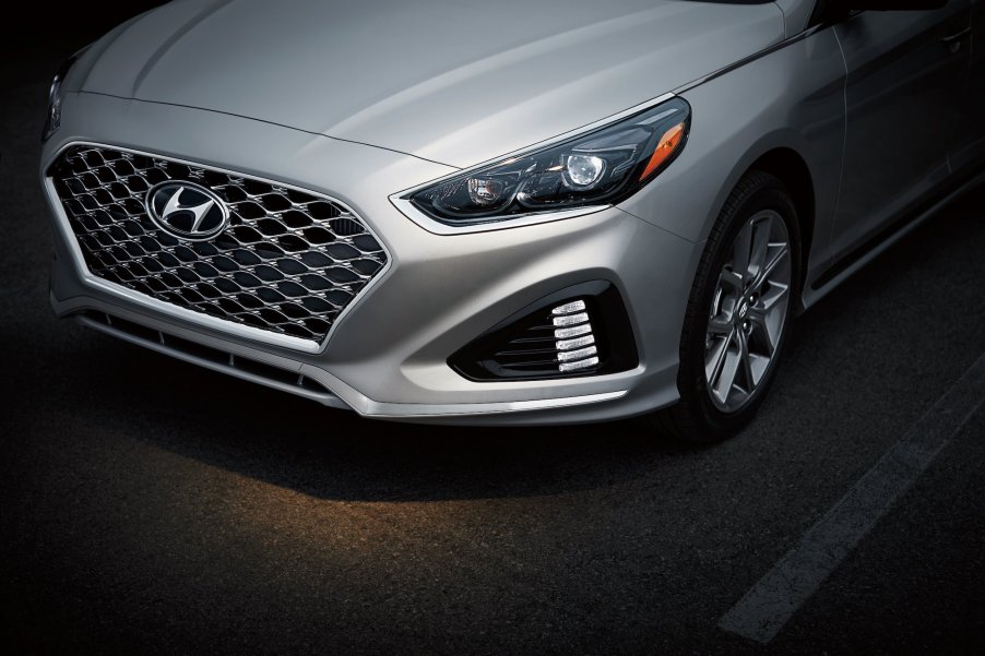 A silver 2019 Hyundai Sonata sedan's grille and driver's side headlight and tire