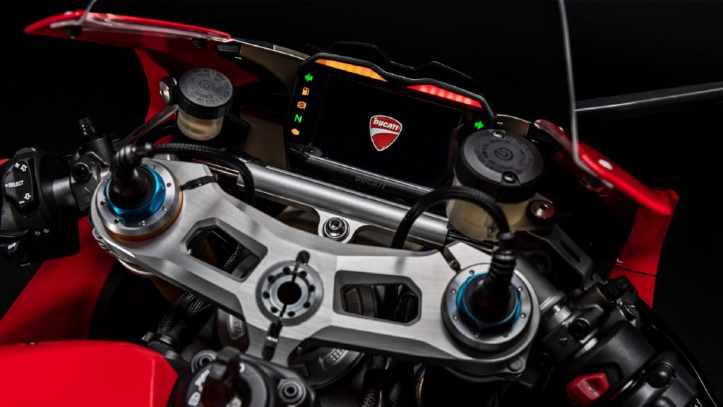 A close-up of a red 2020 Ducati Panigale V4 S's dash with TFT display and a silver Ohlins steering damper