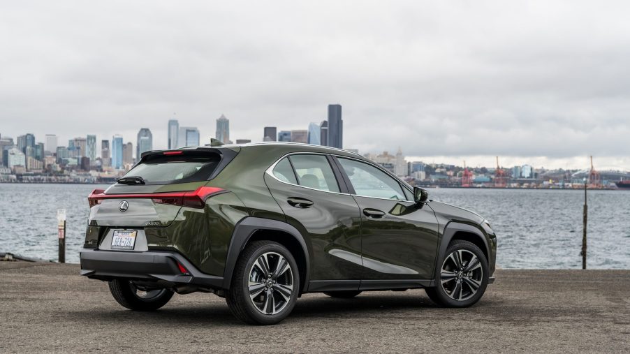 The rear of the Nori Green 2020 Lexus UX overlooking a city skyline and a river