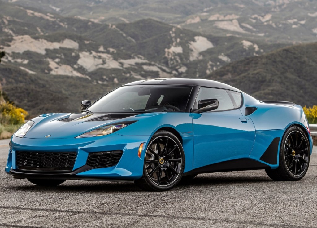 A blue 2020 Lotus Evora GT on a road in the mountains