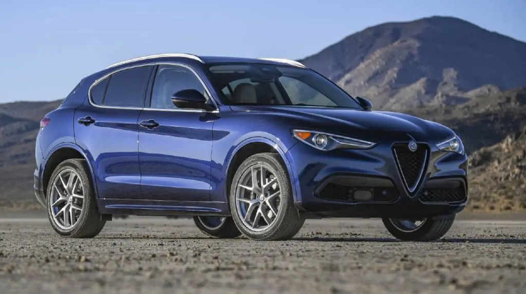 A blue 2021 Alfa Romeo Stelvio in the desert by a mountain