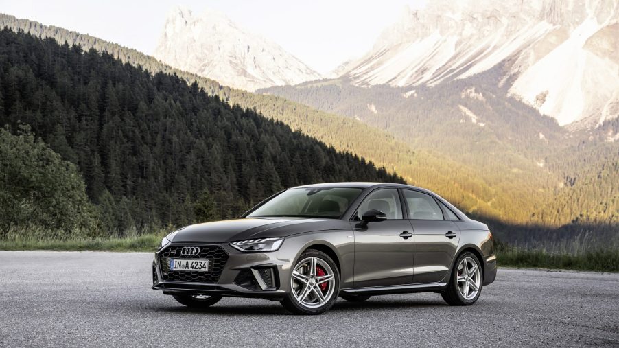 A grey 2021 Audi A4 sedan parked in front of a mountain