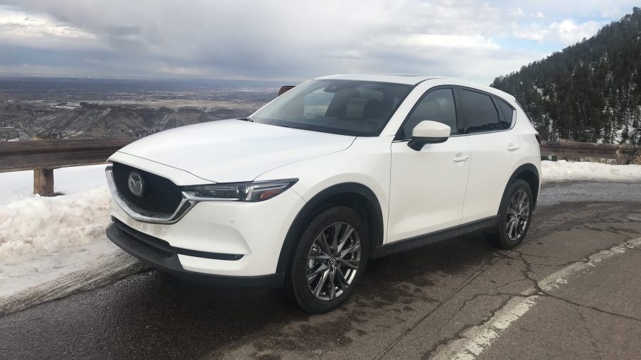 2021 Mazda CX-5 in white posing on a mountain road