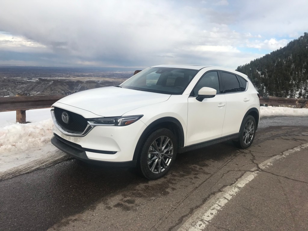 2021 Mazda CX-5 in white posing on a mountain road