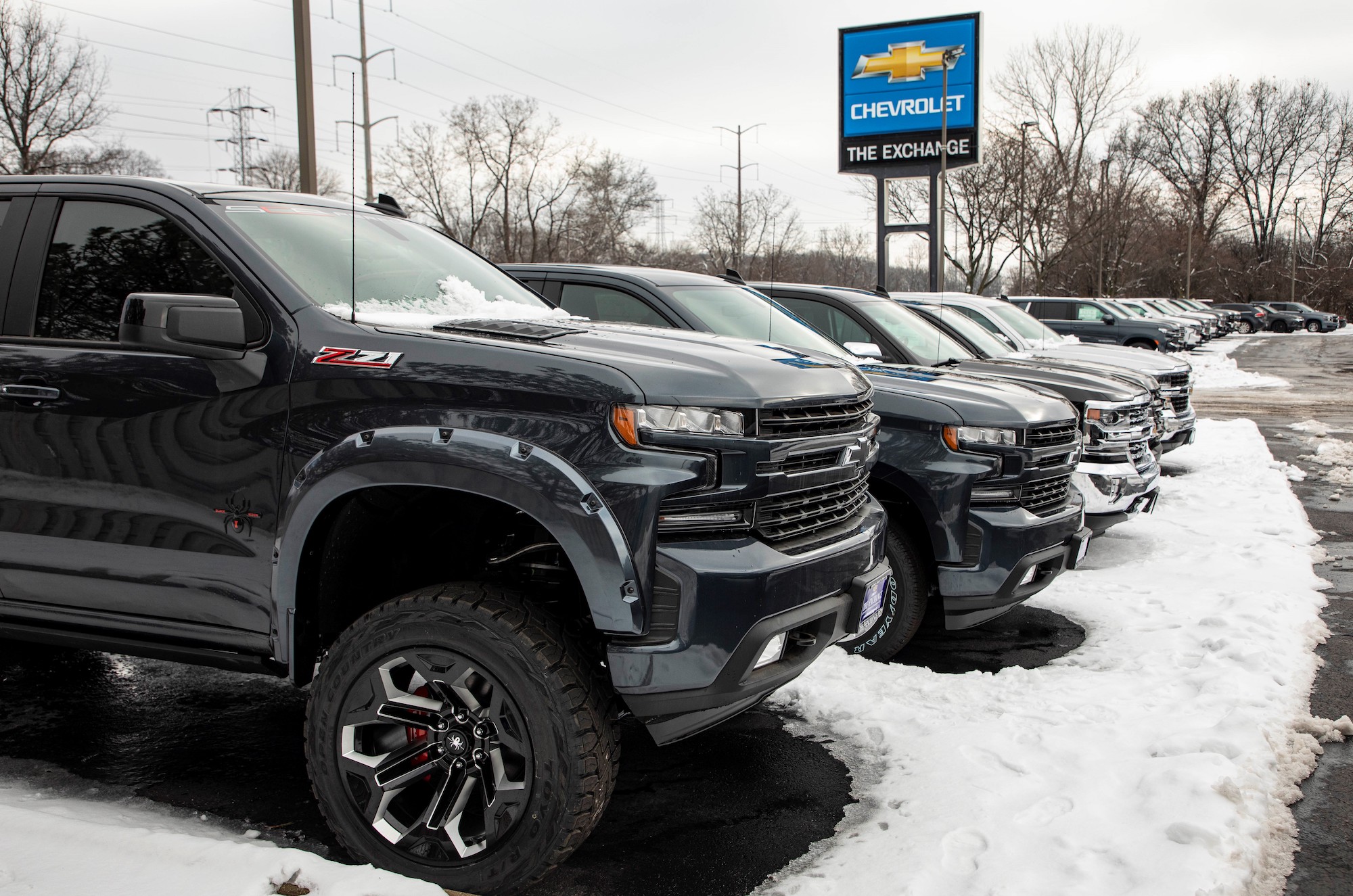 A row of Chevrolet Silverado trucks in a snow-covered parking lot at the Exchange Chevrolet in Lake Bluff, Illinois, on January 5, 2021