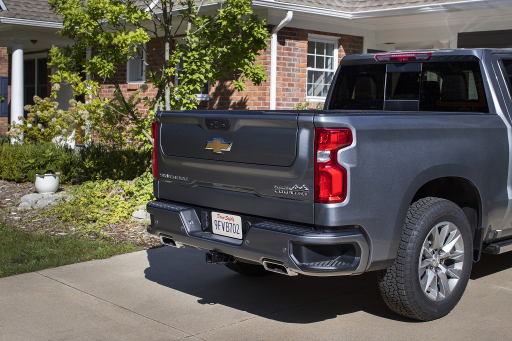 A look at the rear of a 2021 Chevy Silverado that's parked in a driveway in front of a house