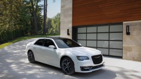A white 2021 Chrysler 300 parked next to a building