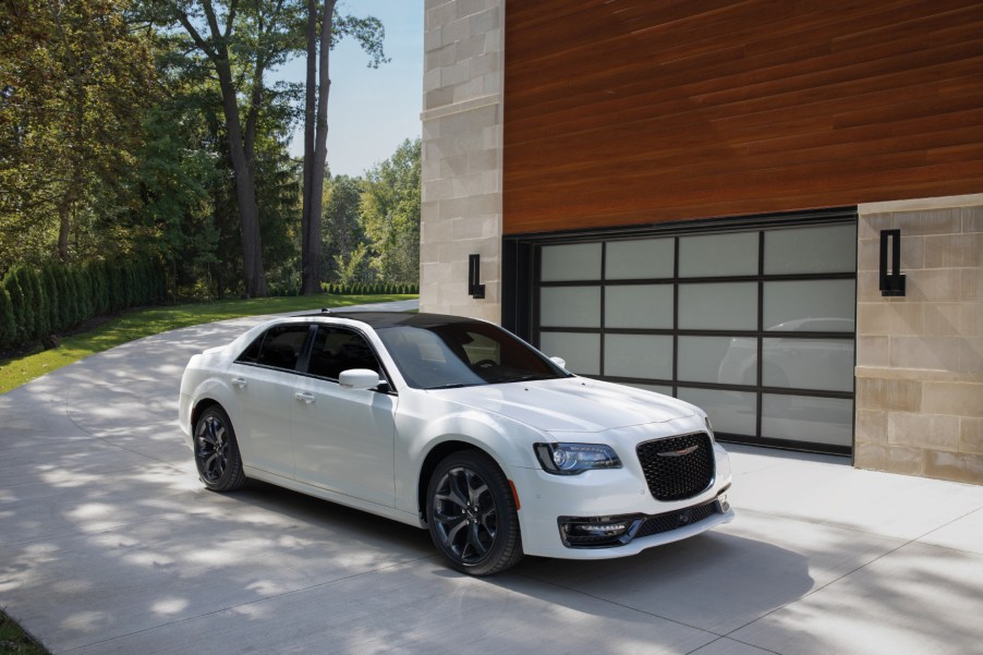 A white 2021 Chrysler 300 parked next to a building