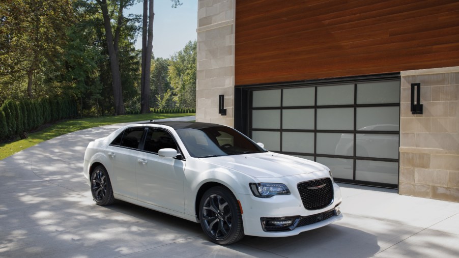 A white 2021 Chrysler 300 parked next to a building