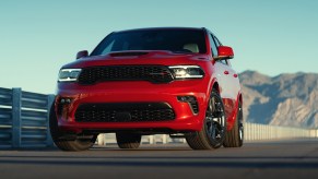 A red 2021 Dodge Durango R/T parked on asphalt in front of mountains