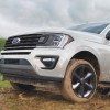 The 2021 Ford Expedition XL STX driving up a dirt hill