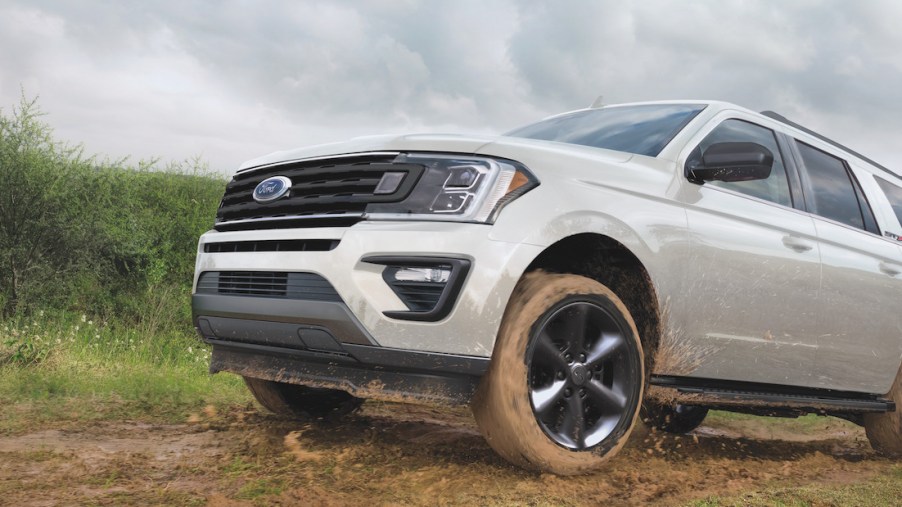 The 2021 Ford Expedition XL STX driving up a dirt hill
