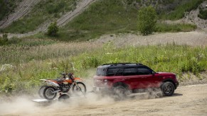A red 2021 Ford Bronco Sport towing a pair of dirt bikes