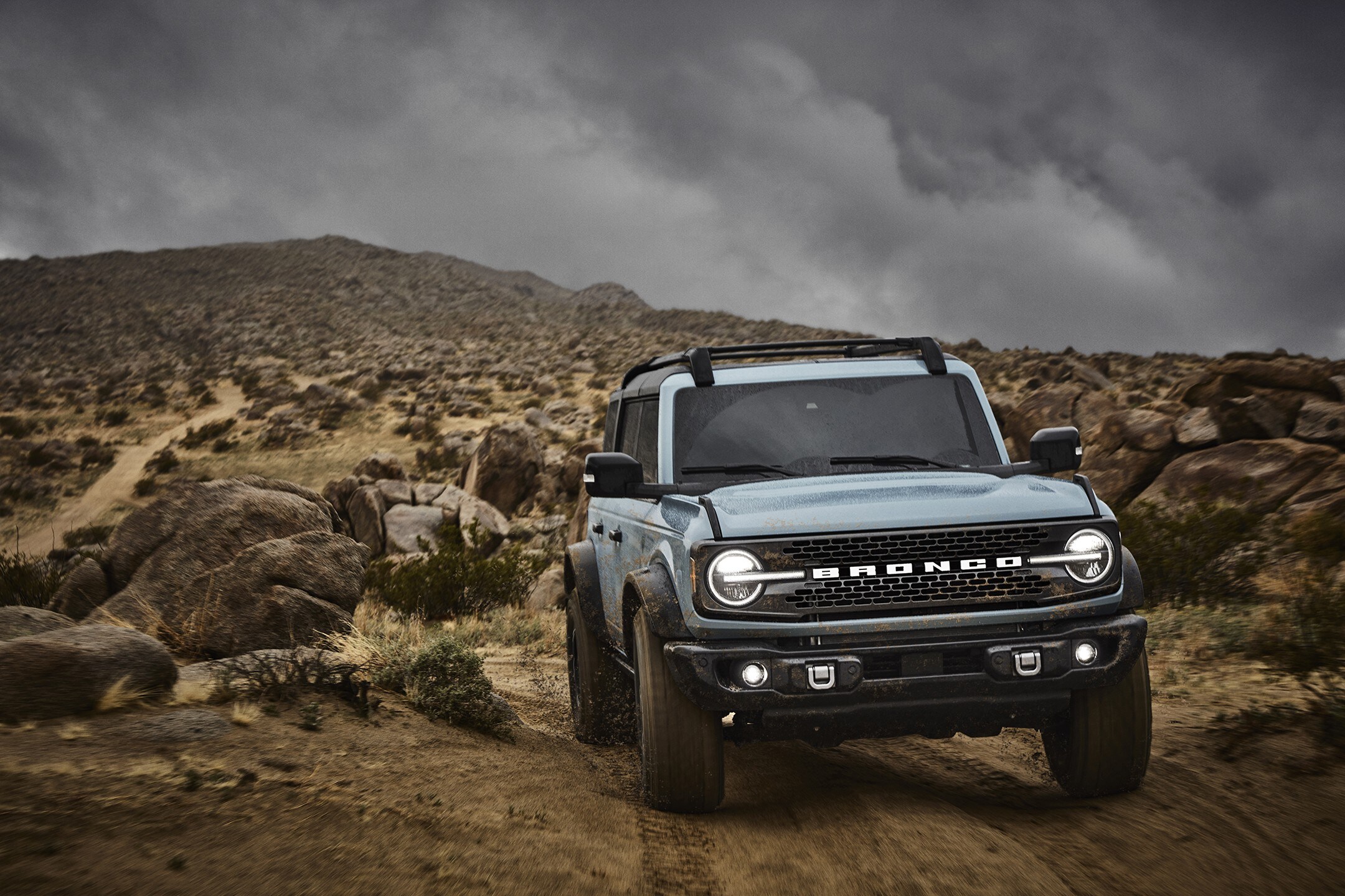 A light blue 2021 Ford Bronco parked on rugged terrain
