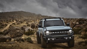A light blue 2021 Ford Bronco parked on rugged terrain