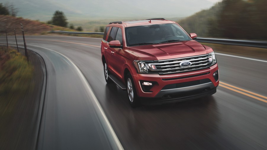 The 2021 Ford Expedition driving down an empty road.