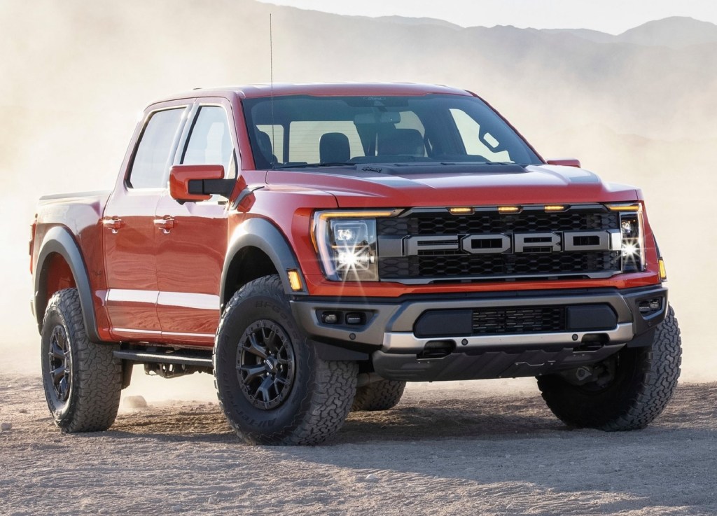 An orange 2021 Ford F-150 Raptor in the desert